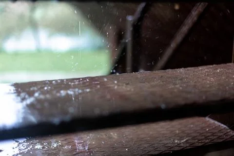 Raindrops dripping on the steps. Brown steps. Stock Photos