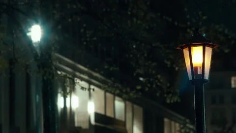 Raindrops fall against the background of a lamppost of a night city street. Stock Footage 285815247