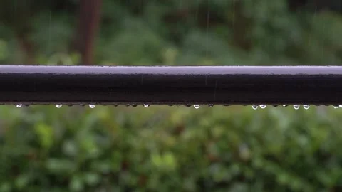 Raindrops fall to the balcony railing and slide down during heavy thunderstorm Stock Footage 139716412