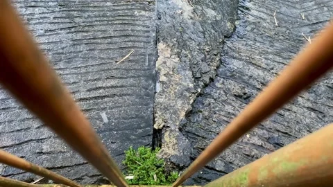 Raindrops fall onto cobbles or cobblestones. Directly above the bars Stock Footage 227071733