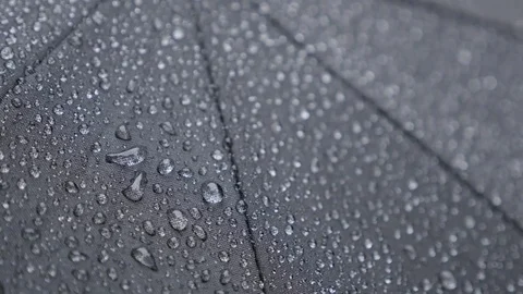 Raindrops fall on dark umbrella surface close up Stock Footage 72273151