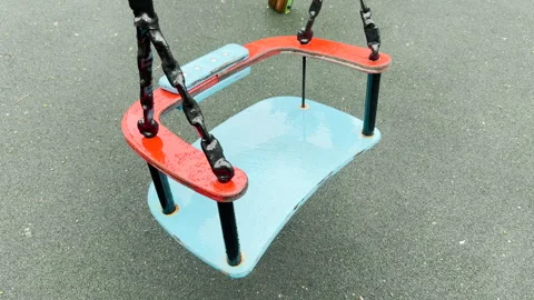 Raindrops Fall On Empty Toddler Swing Seat At Playground Outdoors Stock Footage 336093492