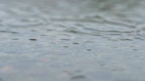 Raindrops fall on the flooded stone surface of the cement road. Vídeos de archivo 205506738