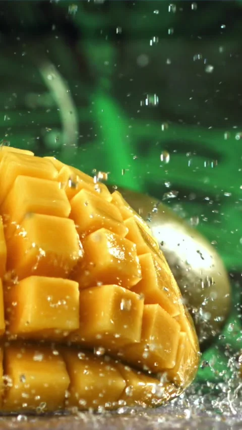 Raindrops fall on fresh mango. Filmed on a high-speed camera at 1000 fps Stock Footage 335315560
