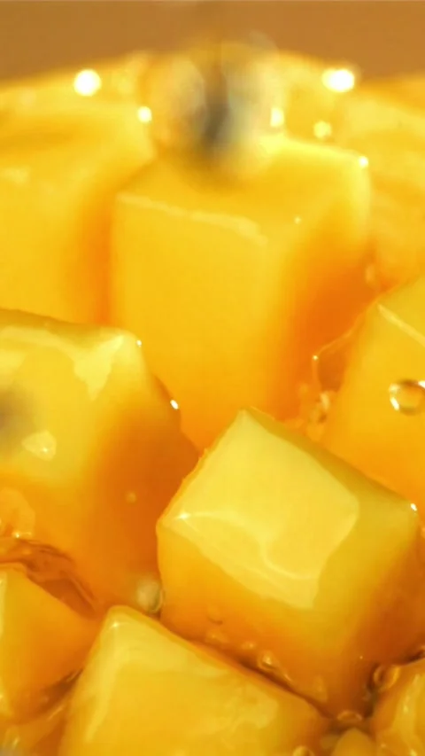 Raindrops fall on fresh mango. Filmed on a high-speed camera at 1000 fps Stock Footage 335319186