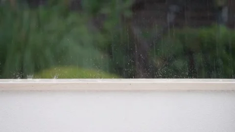 Raindrops fall to the garden wall and splash during thunderstorm in Croatia Stock Footage 142897671