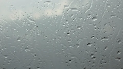 Raindrops fall over glass Stock Footage 90837636