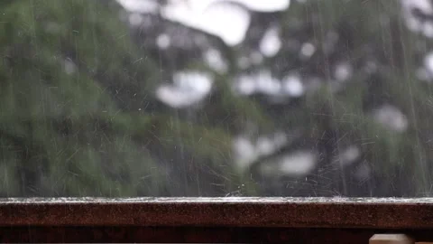 Raindrops fall on the parapet. It's raining hard outside. Blurry background. Video stock 195324548