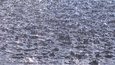 Raindrops fall into a puddle. Slow motion. Stock Footage 160269114