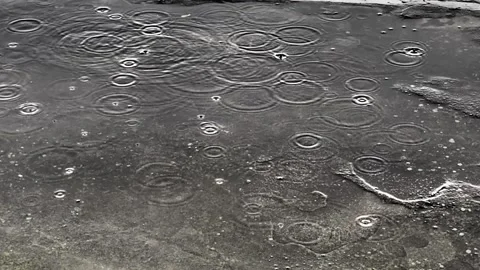 Raindrops fall on the road, asphalt or concrete surface. Rough concrete slab Stock Footage 238829294