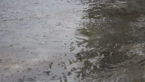 Raindrops fall on the road concrete surface Video stock 297258393