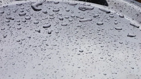 Raindrops fall on a silver metal surface. Close-up shooting. Slow motion.	 库存影片 313367595