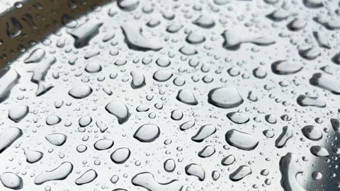 Raindrops fall on a silver metal surface. Close-up shooting. Stock Footage 317386346