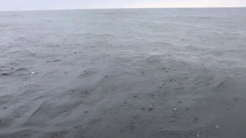 Raindrops fall on the surface of the sea or ocean Stock Footage 135181004