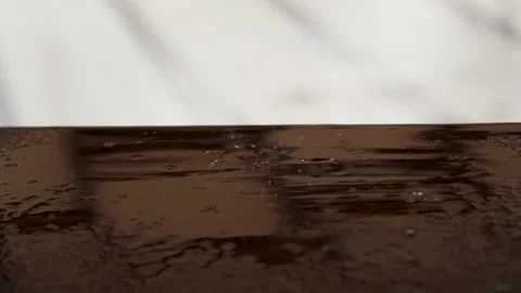 Raindrops fall on the table brown Video stock 131403256