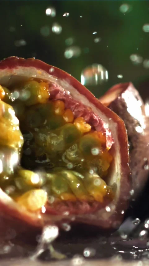 Raindrops fall on tropical passion fruit. Filmed on a high-speed camera at 1000 Stock Footage 335323410