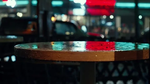 Raindrops fall on a wet cafe table. Stock Footage 285815240