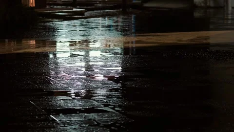 Raindrops fall on a wet night street Stock Footage 311943924