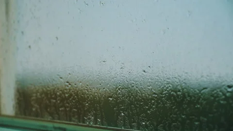 Raindrops Fall on the Window and Window Sill, Flowing Down Stock Footage 201208612