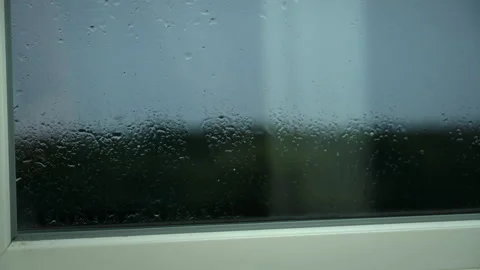Raindrops Fall on the Window and Window Sill, Flowing Down Stock Footage 201234990