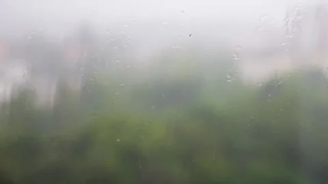 Raindrops fall on a windowsill during a rain. Raindrops on glass. Stock Footage 318191241
