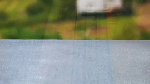 Raindrops fall on a windowsill during a rain. Raindrops on glass. Slow motion.	 Stock-Footage 318191548