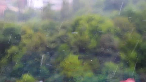 Raindrops fall on a windowsill during a rain. Raindrops on glass. Video stock 318192256