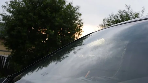 Raindrops fall on the windshield making it wet Stock Footage 91717757