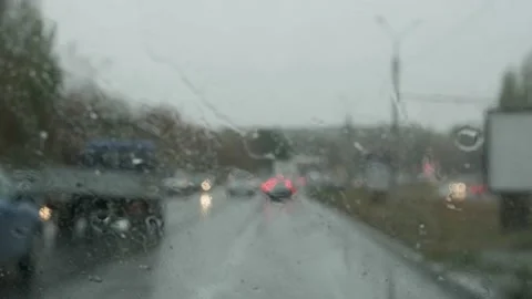 Raindrops fall on the windshield while driving Video stock 142206856