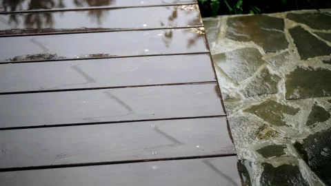 Raindrops fall on a wooden platform during bad weather Stock Footage 316705521