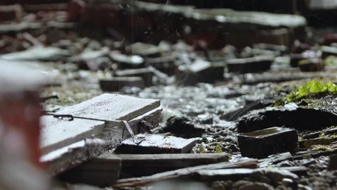 Raindrops falling and landing on a small pool or puddle of water. Stock Footage 220592856