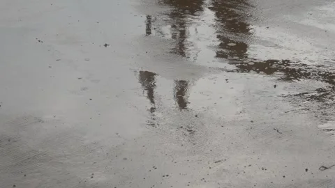 Raindrops falling on asphalt or concrete road surfaces Stock Footage 327193214