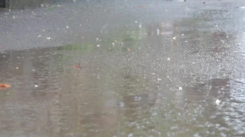 Raindrops falling on asphalt or concrete road surfaces Stock Footage 327193402