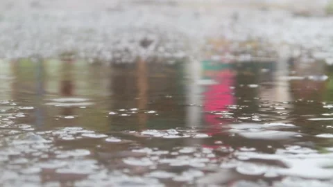 Raindrops falling on asphalt or concrete road surfaces Stock Footage 327193480