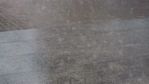 Raindrops falling on asphalt in puddles as background Video stock 132417643