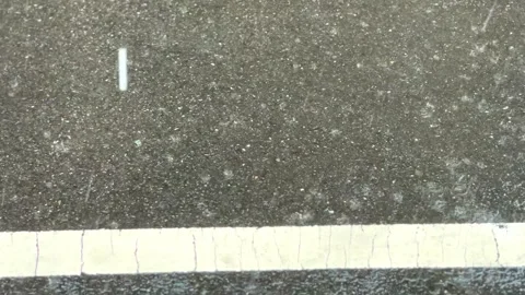 Raindrops falling on the asphalt road Stock Footage 246195635