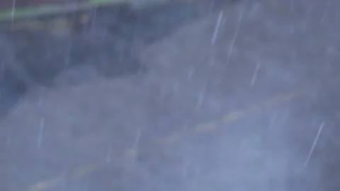 Raindrops falling on the background of the city road Stock Footage 134943631