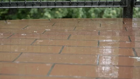 Raindrops falling on balcony floor in slow motion 스톡 동영상 76943532