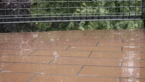 Raindrops falling on balcony floor in slow motion 스톡 동영상 76943681