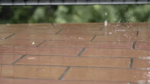 Raindrops falling on balcony floor in slow motion 스톡 동영상 76943869
