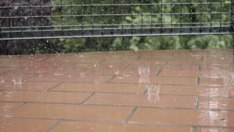 Raindrops falling on balcony floor in slow motion 스톡 동영상 77045738
