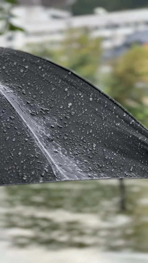 Raindrops Falling on Black Umbrella During Heavy Rainfall Stock Footage 329550199