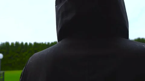 Raindrops Falling on a Black Waterproof Hooded Jacket in Slow Motion Stock Footage 340187762