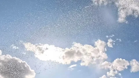 Raindrops falling in blue sky with sun and clouds Stock Footage 315941308