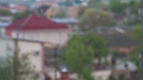 Raindrops falling on blurred outdoor background Stock Footage 129815241