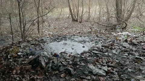 Raindrops falling from a bridge in a puddle of mud Stock Footage 126950694