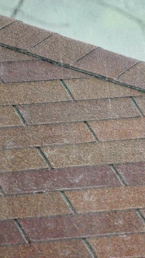 Raindrops falling on brown asphalt shingles of house roof during spring sto.. Stock Footage 334912309