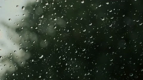Raindrops falling on car window.  4K UHD Stock Footage 220715787
