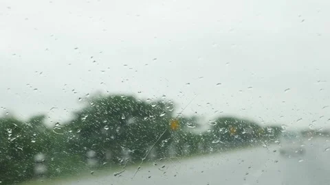 Raindrops falling on car windshield 動画素材 156954422