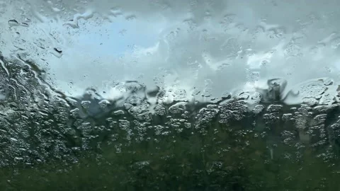 Raindrops falling on car windshield Stock Footage 162980037